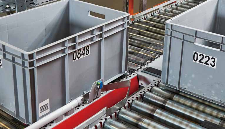 Large plastic crates on a production conveyor